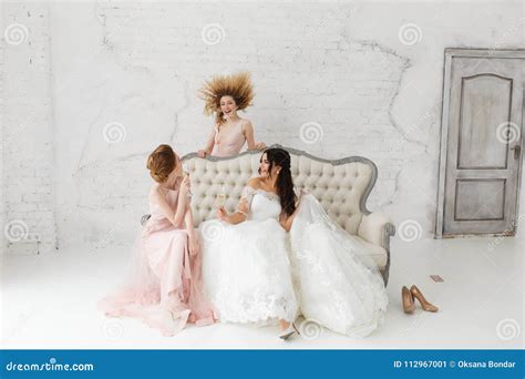 Bride And Bridesmaids Fooling Around And Drink Champagne Stock Image