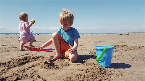 Children Playing On The Beach By Stocksy Contributor Sally Anscombe