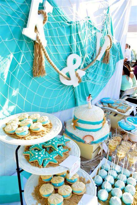 Laura wanted to incorporate the beach into her wedding cake and she found a cake designer who mastered that challenge. Dessert table- Dessert table-beach theme #seashells # ...