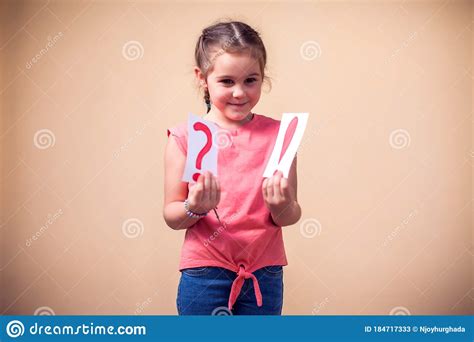 A Portrain Of Kid Girl Holding Cards With Question Mark And Exclamation