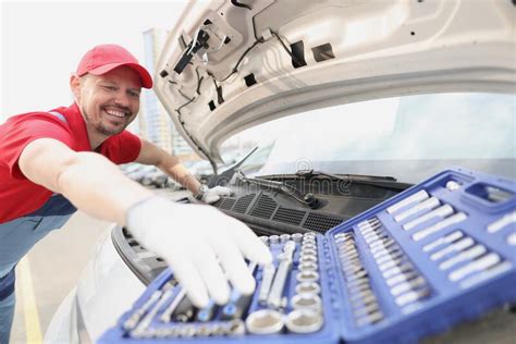 Automotive Technician Smiling And Take Instrument From Open Kit Stock