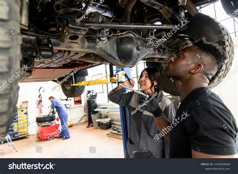 Auto Mechanics Working Under Suv On Stock Photo 2128168568 Shutterstock