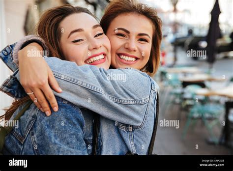 Close Up Photo Of Two Attractive Happy Woman Friends Hugging Each Stock