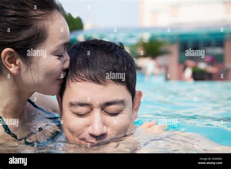 Young Couple Kissing In Swimming Pool Hi Res Stock Photography And