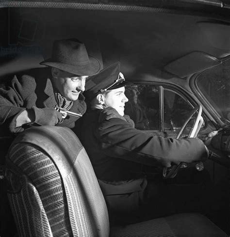 An Arranged Scene Where A Man Holds A Taxidriver Under Gun Threat