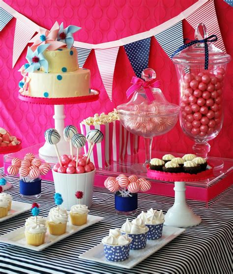A Table Topped With Lots Of Cupcakes And Cake Next To Dessert Cups