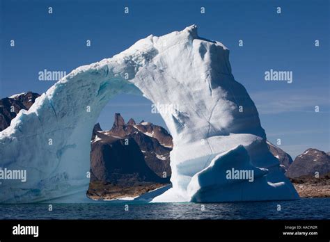 Greenland Frederiksdal Arched Iceberg Frames Mountain Peaks On