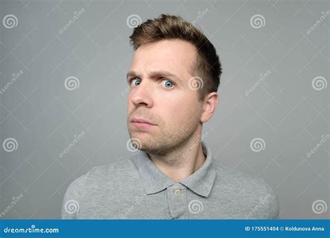 Expressive Caucasian Man Frowning At Camera Studio Shot Stock Photo