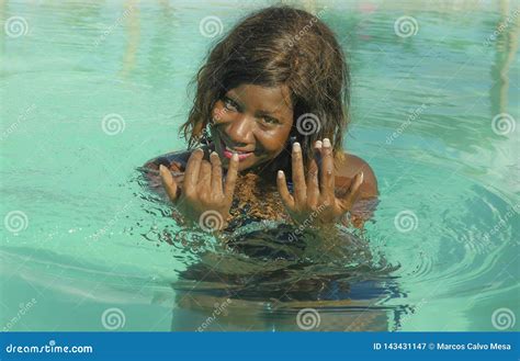 happy and beautiful black african american woman in bikini having fun at tropical beach resort
