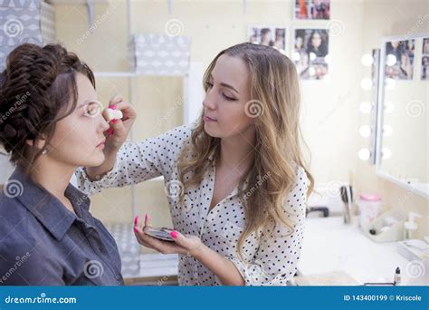 Stylist Makeup Artist Doing Makeup And Hair In A Beauty Salon Professional Make Up Stock Image