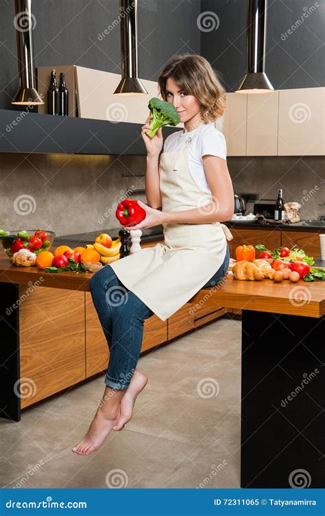 Pretty Housewife In The Kitchen Sitting On Table Stock Image Image Of