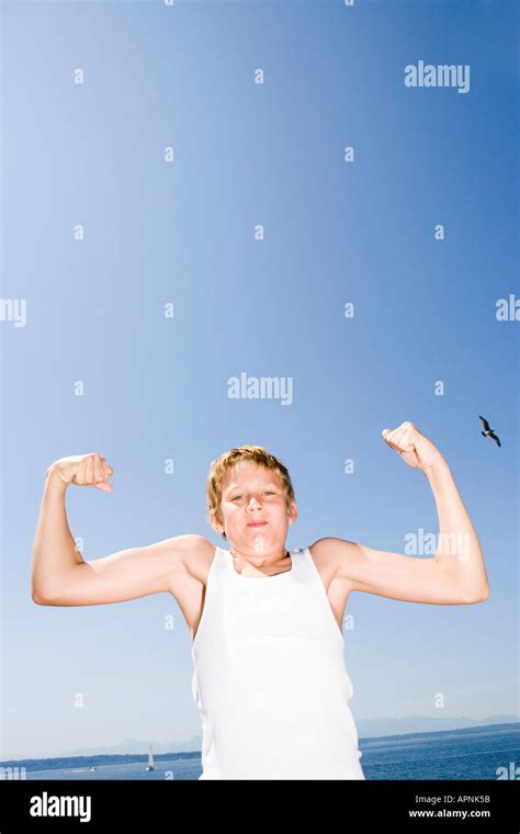 Young Boy Flexing His Muscles Stock Photo Alamy