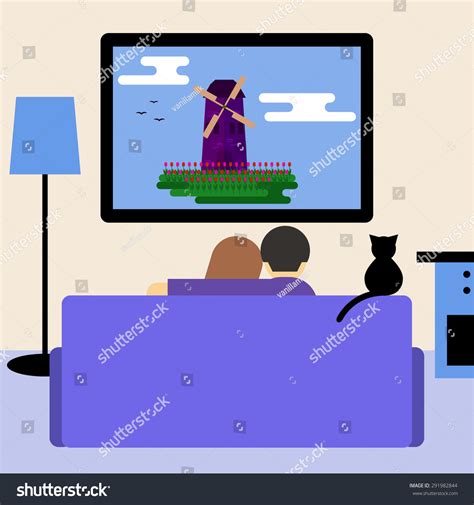 Couple And Cat Watching Television Sitting On The Couch In Room