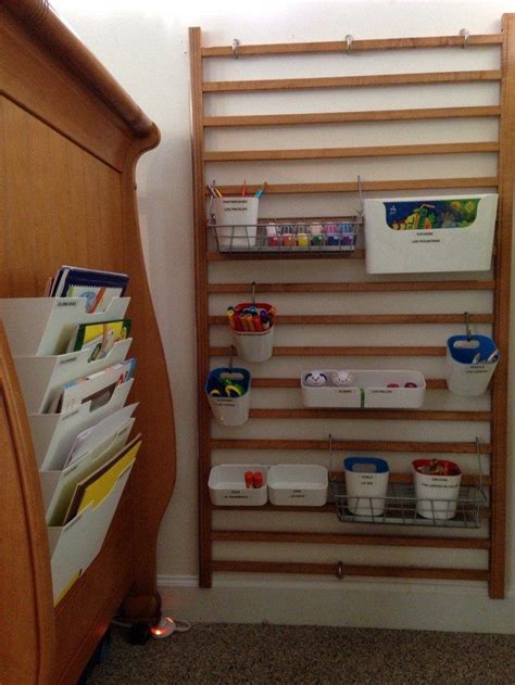 The Shelves Are Organized With Plastic Containers And File Folders
