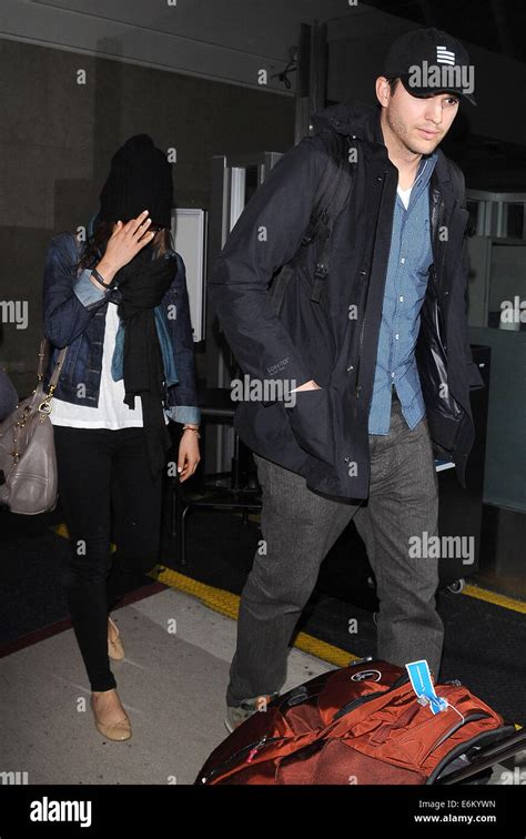 Ashton Kutcher And Mila Kunis Arrive At Los Angeles International Lax Airport Featuring