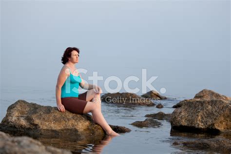 Woman Sitting On Rocks In Sea Stock Photo Royalty Free Freeimages