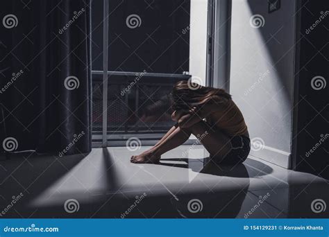 Depressed Young Woman Sitting Alone On The Floor In The Living Room