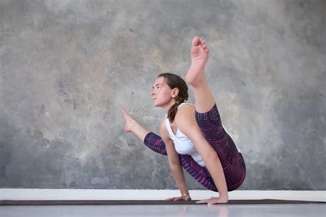 Woman Doing Handstand Variation Of Firefly Posture Tittibhasana