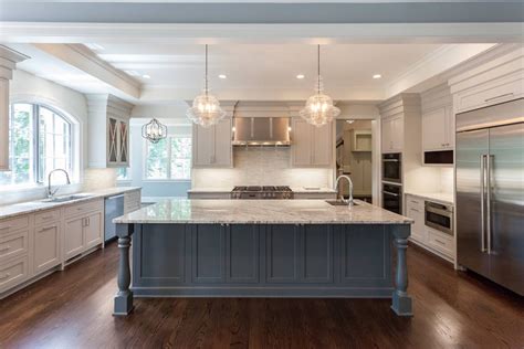 Kitchen With Contrast Gray Island And Beige Cabinets Featuring Arched