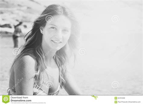 Beautiful Tanned Girl In A Bikini Sitting On A Rocky Beach Hot Sex