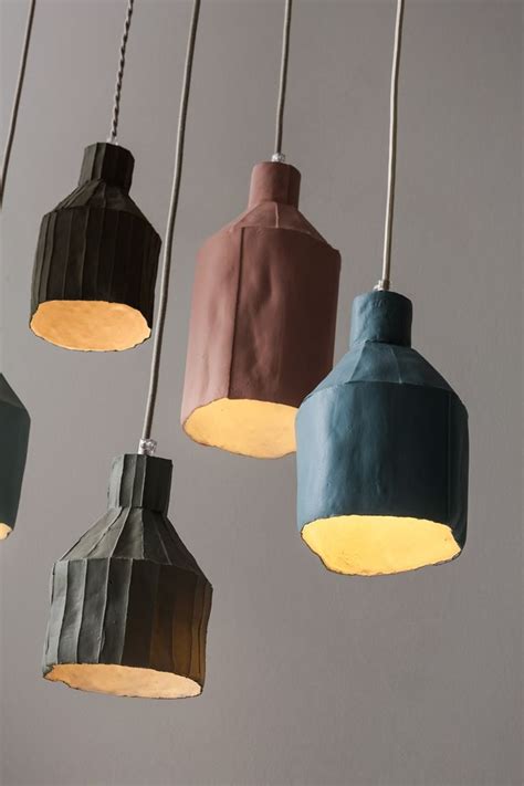 Five Different Colored Lamps Hanging From The Ceiling