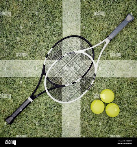 Tennis Rackets And Balls Are Located On Grass Court Top View Stock