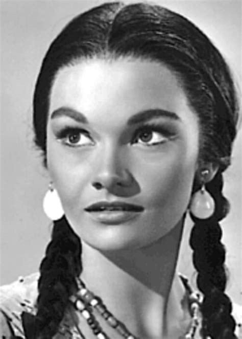 A Black And White Photo Of A Woman With Braids In Her Hair Wearing Earrings