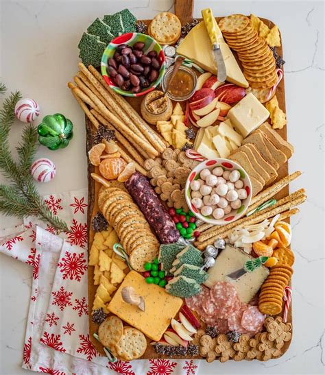 Beautiful cheese board filled with tomatoes, baguettes and meats. DIY Christmas Cheese Board for a Party | Recipe ...