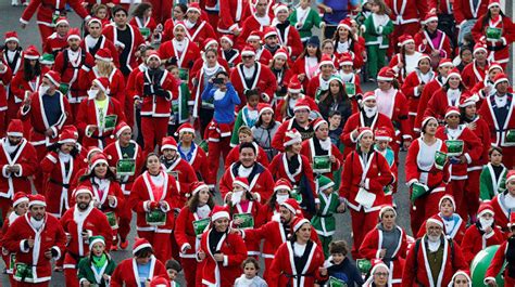 Thousands Dressed As Santa Claus Race Through Madrid For Charity
