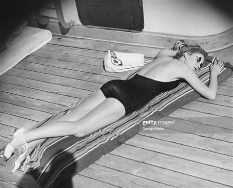 Young Woman Sun Tanning On Cruiser Deck Elevated View Photo Getty Images