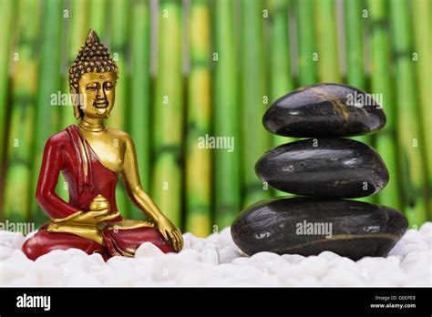 Zen Garden With Buddha Figure And Stacked Stones Stock Photo Alamy