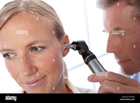 Ear Examination General Practice Doctor Using An Otoscope To Examine A