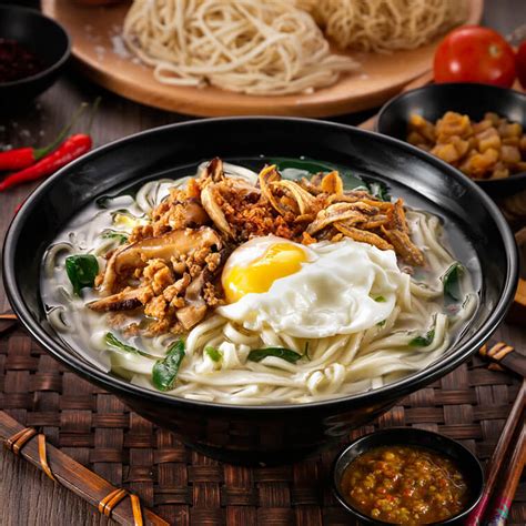 To assemble the chili pan mee, first add the poached egg onto the noodles, followed by the pak choy, 1 teaspoon of chili oil, the cooked mince chicken and some fried anchovies. Menu | Chilli Pan Mee