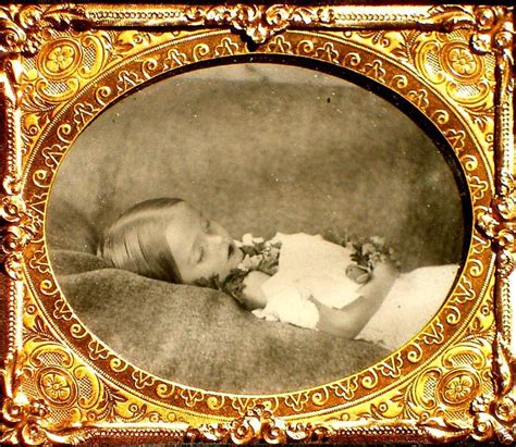 this is a beautiful postmortem photo a little sleeping beauty with flowers placed in her hands