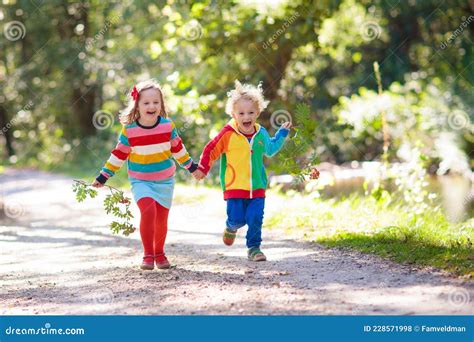 Kids Play In Autumn Park Stock Photo Image Of Laughing 228571998
