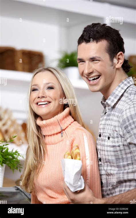 Attractive Couple With Rolls In Shop Stock Photo Alamy