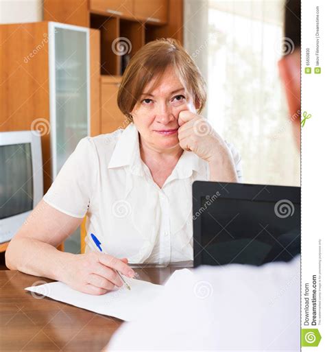 Mature Woman Answer Questions Of Worker Stock Photo Image Of Case
