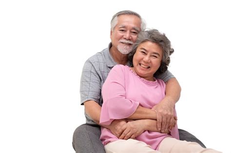 Premium Photo Asian Senior Couple Sitting And Hugging Together Isolated On White Background