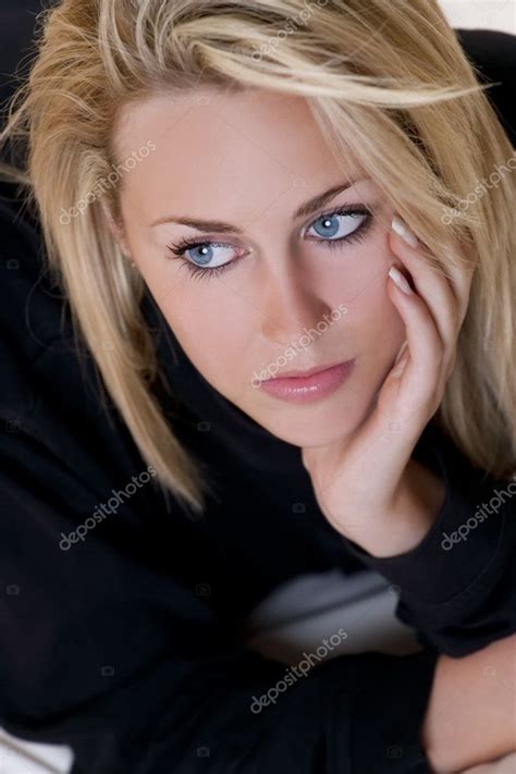 Beautiful But Sad Young Blond Woman With Blue Eyes Stock Photo By