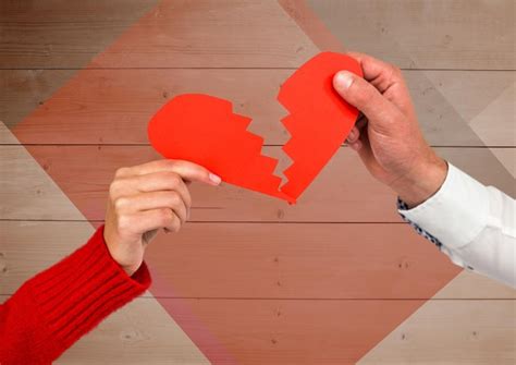 Premium Photo Couple Holding Broken Heart Against Wooden Background