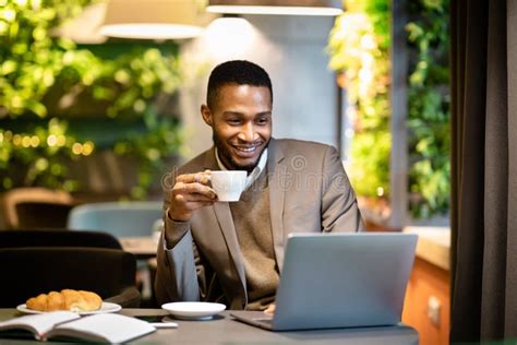 Black Guy Holding Cup Of Coffee Working In Office Stock Image Image