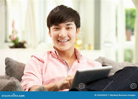 Young Chinese Man Using Digital Tablet Stock Photo Image Of Sitting