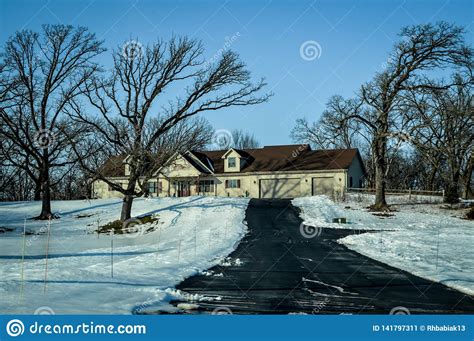 Ranch House With Long Driveway In Winter Stock Image