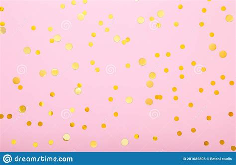 Gold Confetti Sparkles On Pink Background Flat Lay Top View Festive