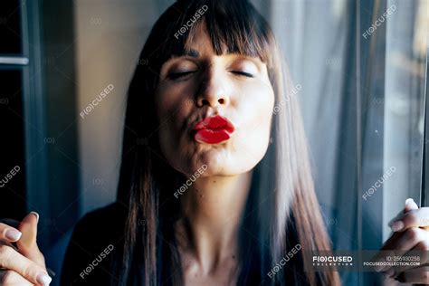 Attractive Female With Red Lips Kissing Clean Transparent Glass