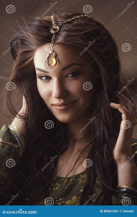 beautiful egyptian woman like cleopatra on golden background stock image