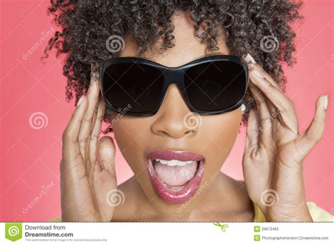 Close Up Of An African American Woman Wearing Sunglasses Over Colored