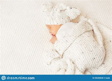 Newborn Sleeping On Stomach Cute Baby In Knitted Hat Covered With