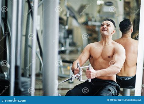 Muscular Arab Man Training In Modern Gym Fitness Arabian Men With Naked Torso Doing Exercises