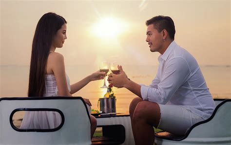 Asian Couple In Romantic Dinner With Sea Beach And Sunset In Thi